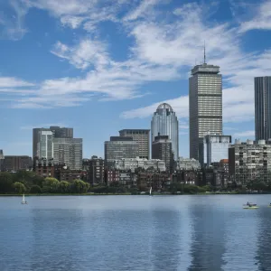 a city skyline with a body of water in front of it