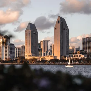 a sailboat in front of a city