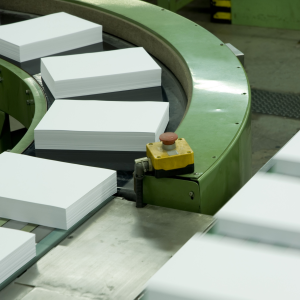 Stacks of cut paper sheets moving along a conveyor