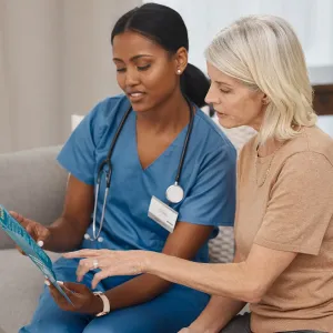 A female nurse and a female patient reviewing an informational pamphlet