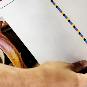 A hand holding a printed sheet