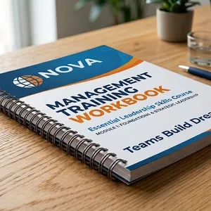 Wire-O bound management training workbook on wooden desk with pen and laptop