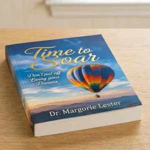 Perfect Bound book titled Time to Soar with hot air balloon and inspirational subtitle on wooden table.