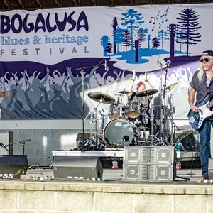 Live blues band performing on stage at the Bogalusa Blues and Heritage Festival outdoor event.