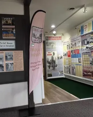 Interior view of Turner’s Lodge Pro Golf Museum featuring historic golf photos and displays about LPGA and PGA history.