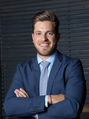 a man in a suit with his arms crossed