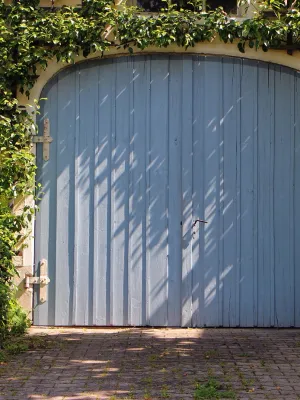 a blue gate with a white door