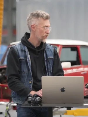 a couple of men looking at a laptop