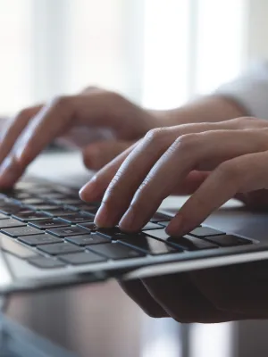 a close-up of hands on a laptop