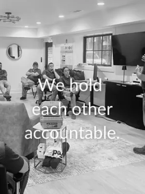 Team members seated and listening to a speaker in a meeting room with text overlay about accountability.