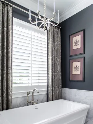 a bathtub with a chandelier above it