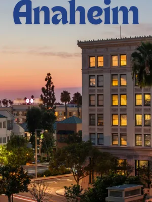 a building in Anaheim with trees, showing Anaheim at dusk.