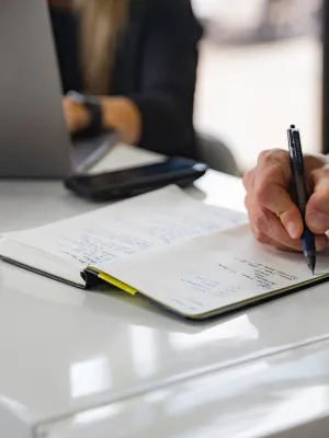 a person writing on a piece of paper