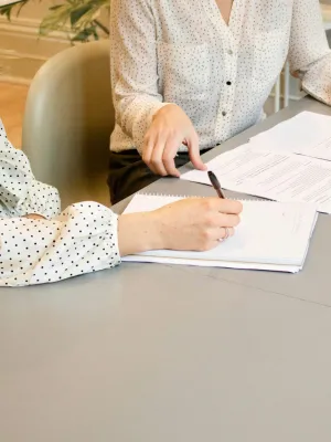 a man and a woman writing on paper