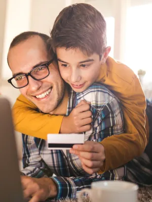a man and a boy looking at a cell phone