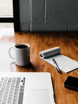 a laptop computer sitting on top of a wooden table