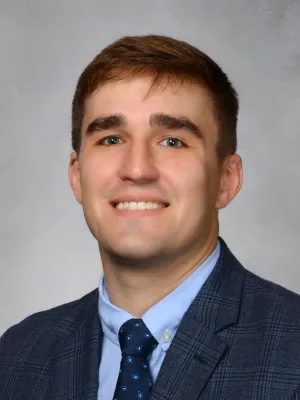 a man in a suit smiling