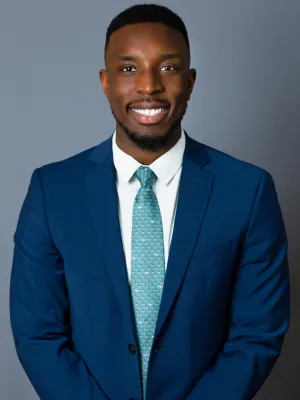 a man in a suit smiling