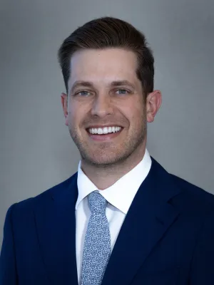 a man in a suit smiling