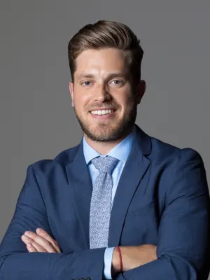 a man in a suit with his arms crossed