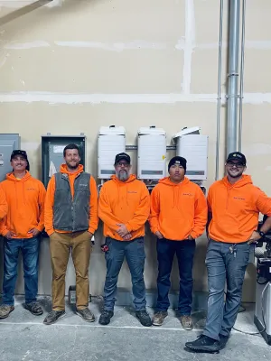 a group of people wearing orange jackets