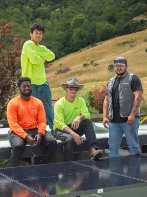 a group of men posing for a photo on a roof