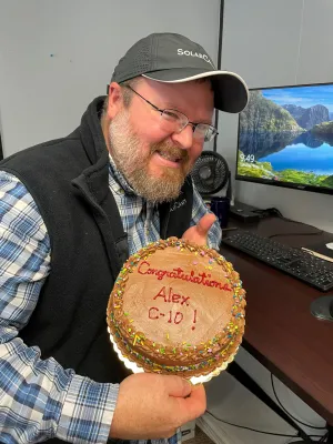 a man holding a cake