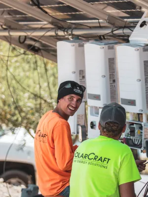 a couple of men standing next to a machine