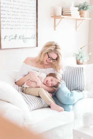 a woman and a baby on a couch
