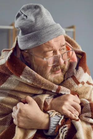 a person wearing a hat and holding a baby