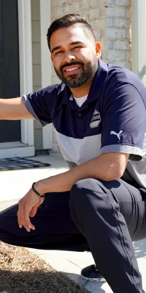 a man sitting on a curb next to a sign