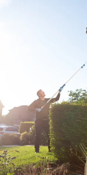 a Ridd technician holding a pest control sprayer