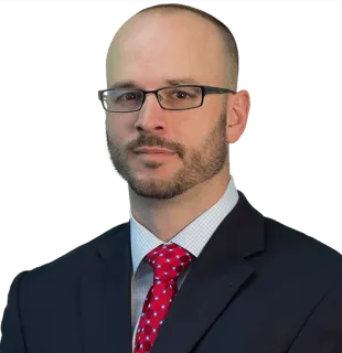 a man wearing glasses posing for the camera