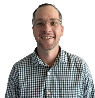 Smiling man wearing glasses and a green checkered shirt on a white background