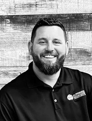 a man with a beard smiling