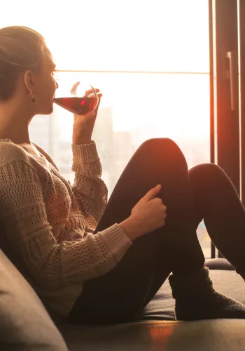 a woman sitting in front of a window