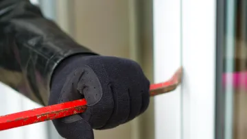 a black glove with red and white stripes