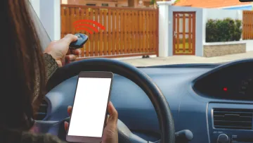 a person holding a phone and sitting in a car