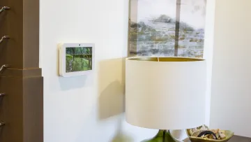 a white lamp with a painting on the wall