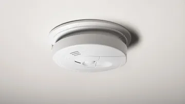 a smoke detector on a white surface