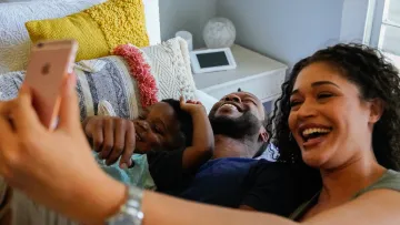 a woman taking a selfie with a man and a dog