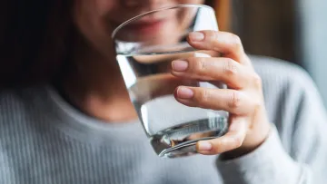 a person holding a glass of water