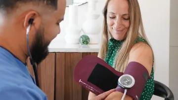 a man holding a phone and a woman looking at a cell phone