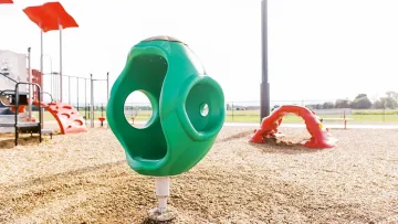 a couple of green and red playground toys