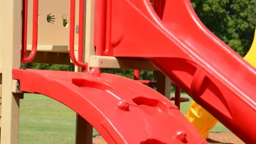 a red and yellow playground toy