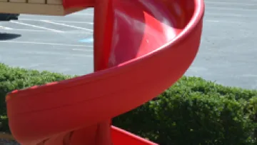 a red chair in a parking lot