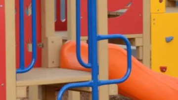 a playground with blue and yellow slide