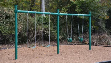 a playground with green poles