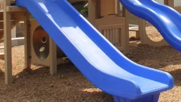 a blue slide on a playground