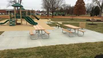 a playground with a slide and tables
